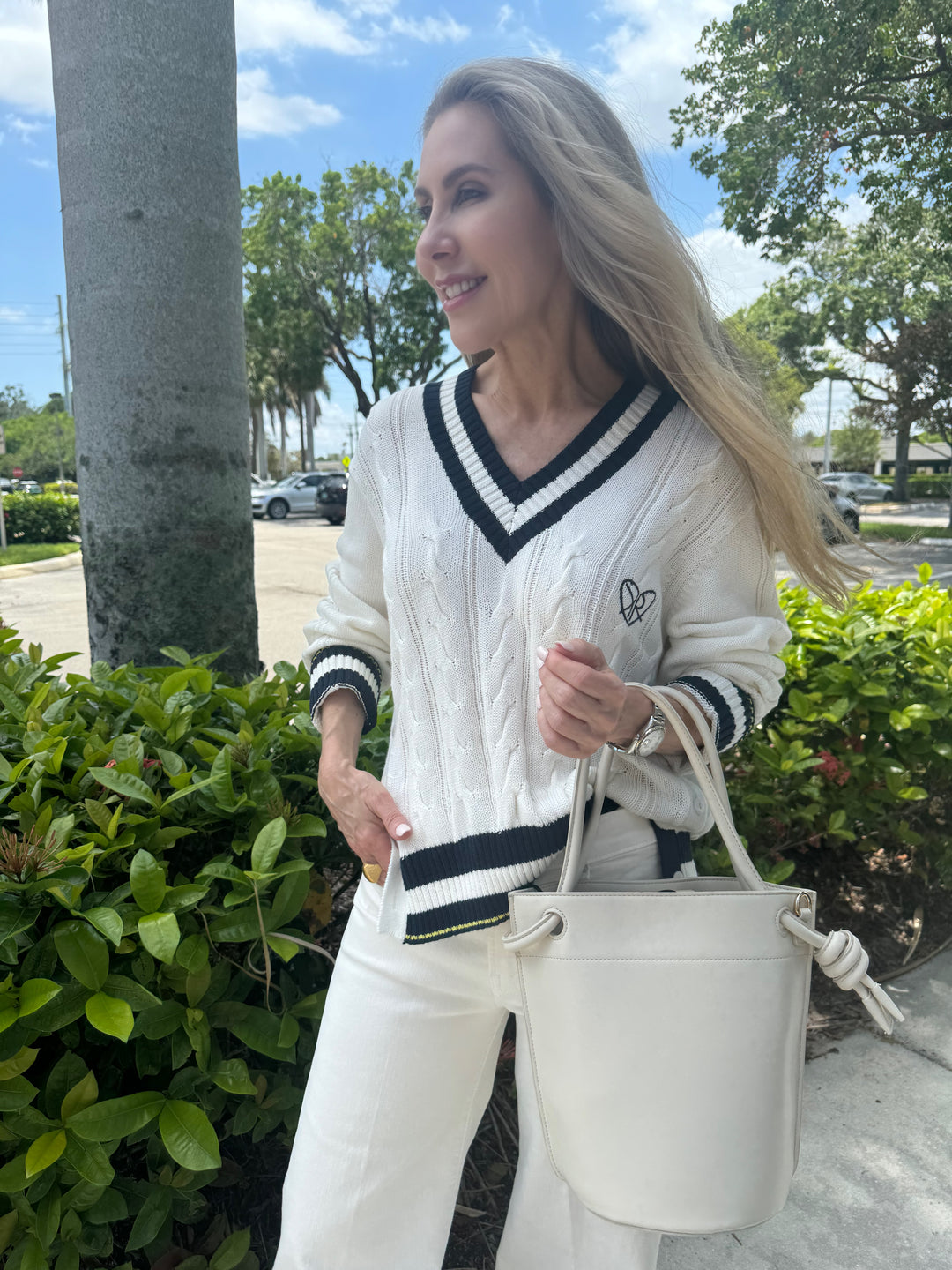 Kerri Rosenthal Patvee Sweater in White, 100% cotton pullover sweater with v neck, long sleeves, cable stitch design, embroidered KR logo, side slits with faux shell buttons for closure