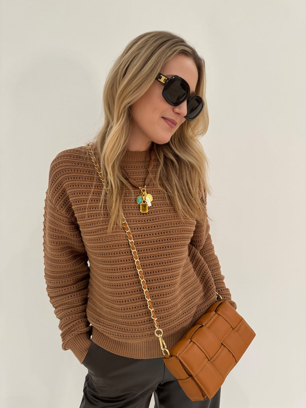 Varley Jarvis Relaxed Sweater in Golden Bronze paired with Max Mara Leisure Struzzo Vegan Leather Pants in Hazelnut, shown with BK Square Weave Leather Crossbody Bag in Camel and Lizzie Fortunato Marilla Necklace - all available at BarbaraKatz.com