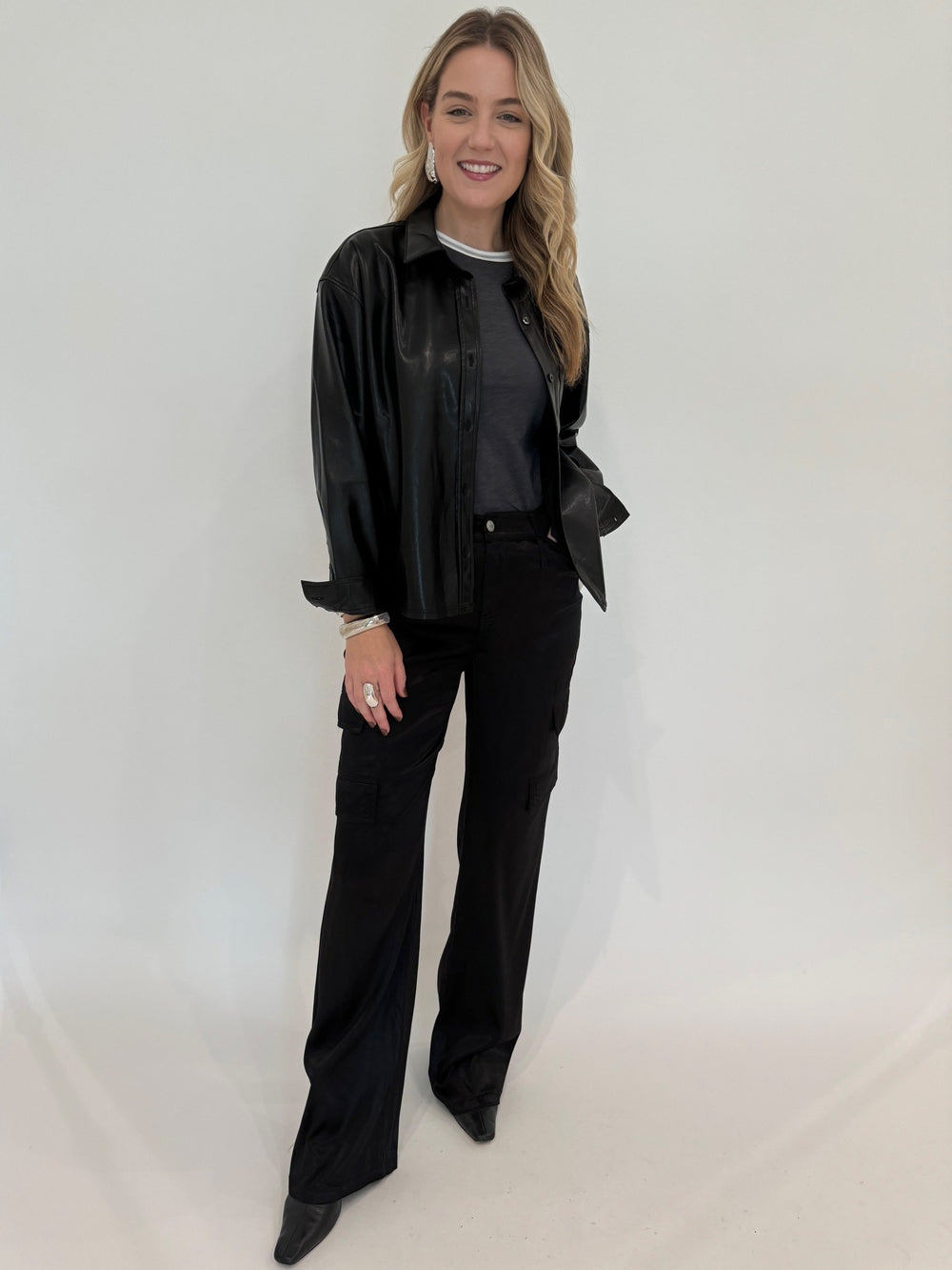 Melissa Nepton Driane Faux Leather Shirt in Black with Goldie Metallic Tipped Ringer Tee in Iron underneath, paired with Marrakech Zendaya Silky Cargo Pants in Black available at Barbara Katz