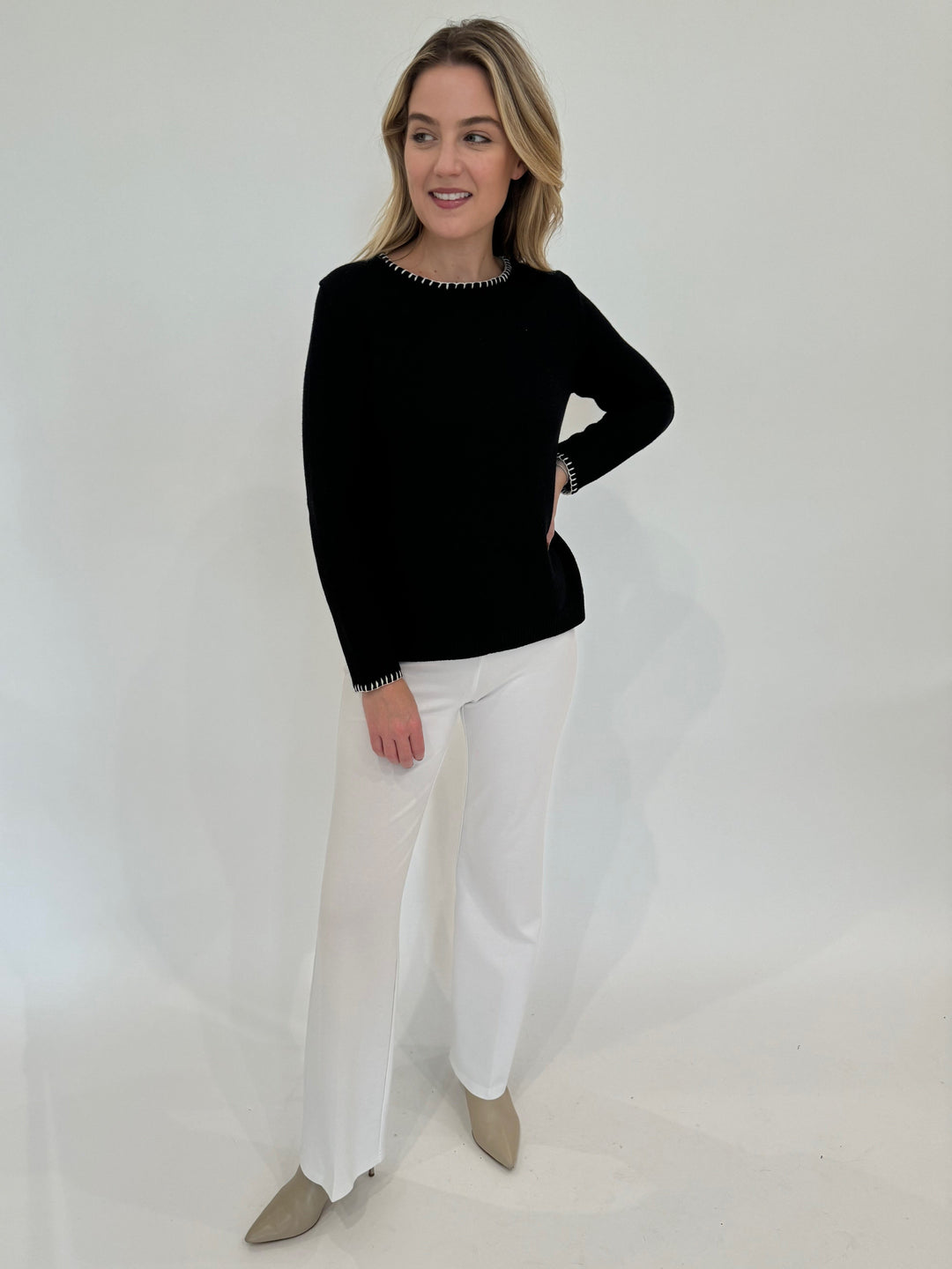 Kinross Cashmere Shimmer Splitneck Long Sleeve Sweater in Black paired with Peace of Cloth Jules Paramount Knit Pants in White available at Barbara Katz