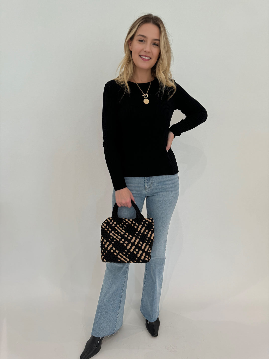 Peace of Cloth Cotton Crew Jacquard Sweater in Black paired with Frame Le Easy Flare Raw Fray Jeans and Sol and Selene Sky's Small Tote Bag in Black/Nude