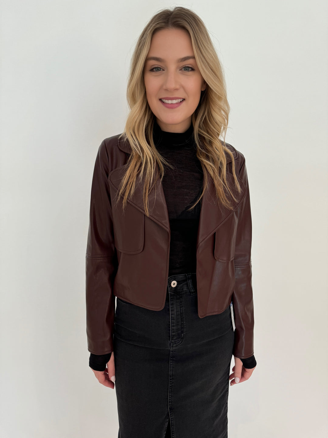 Adroit Atelier Ninon Vegan Leather Jacket in Chocolate with Aldomartins Black Norin Top underneath, paired with Elliott Lauren Geneva Jean Midi Skirt available at Barbara Katz