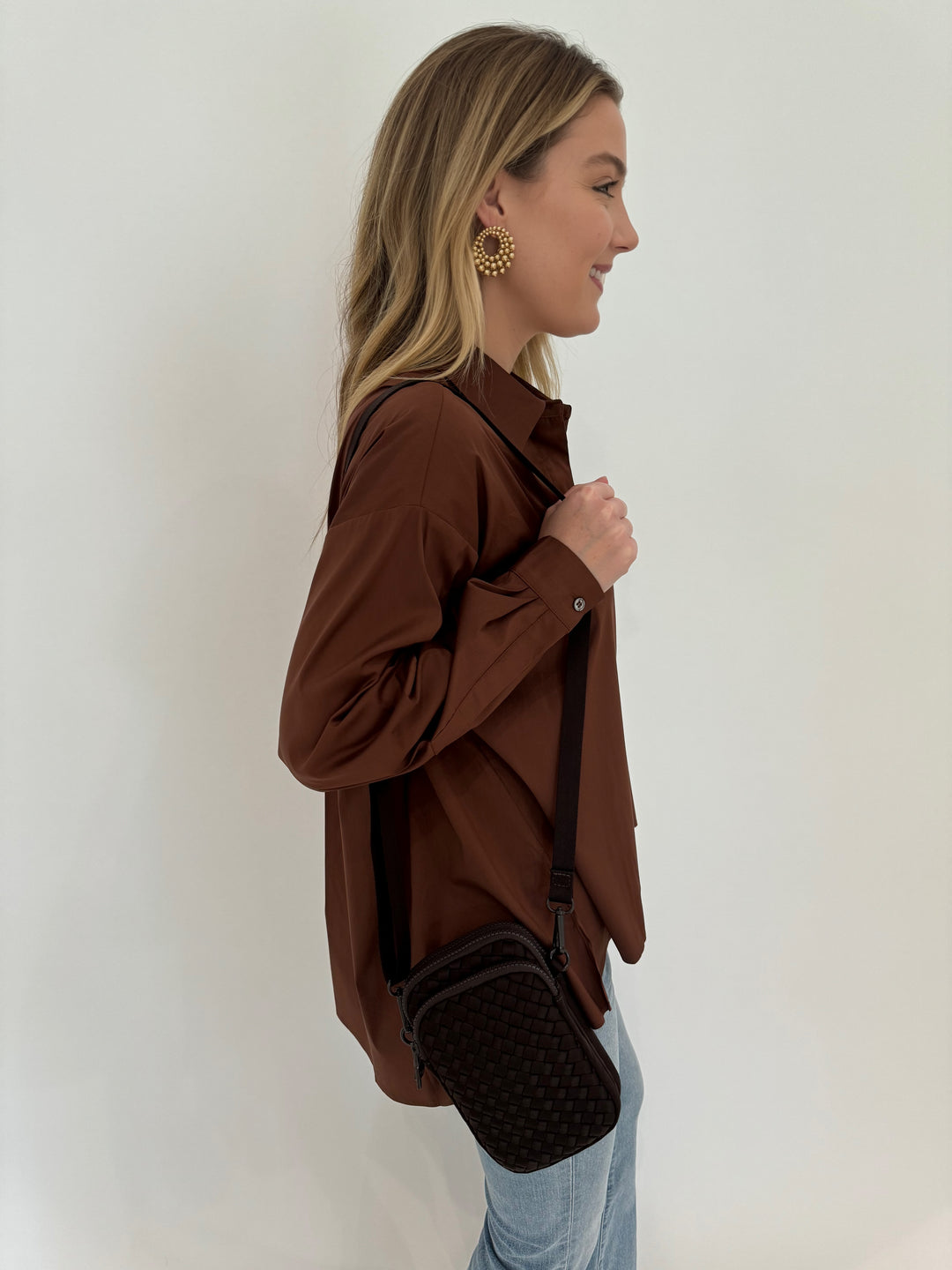 Repeat Blouse With Side End Slits in Brown paired with Frame LeEasy Flare Raw Fray Jeans, and Sol and Selene Divide & Conquer Woven Crossbody Bag in Chocolate