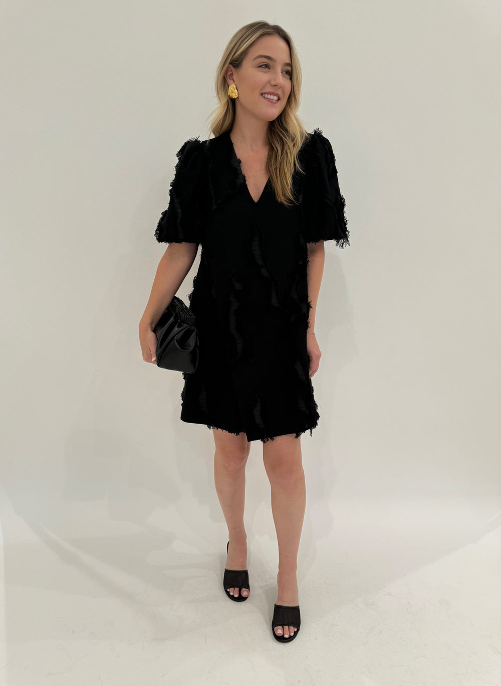 Stine Goya Puffy Sleeves Mini Dress in Black with Mignonne Gavigan Christopher Stud Earrings in Gold, DeMellier Miami Clutch in Black - all available at Barbara Katz