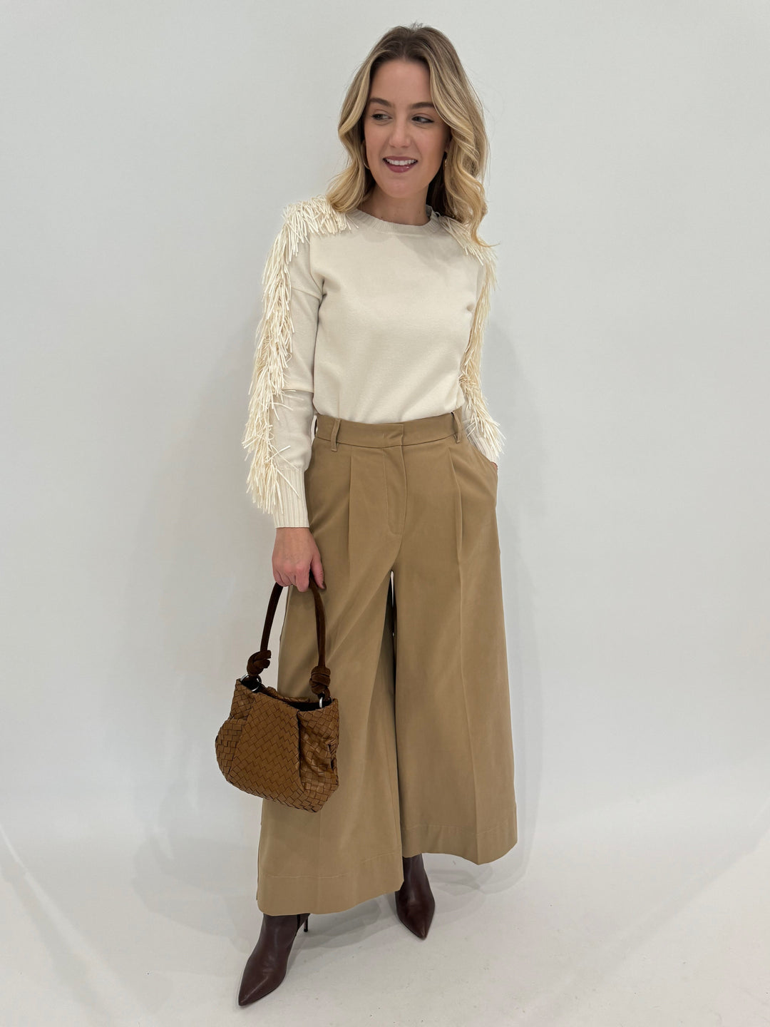 D.Exterior Fringe Sleeve Crew Sweater in Latte paired with Max Mara Weekend Caprile Button Side Pants in Beige and Daniella Lehavi Caramel Woven Bali Knotted Bag - all available at Barbara Katz