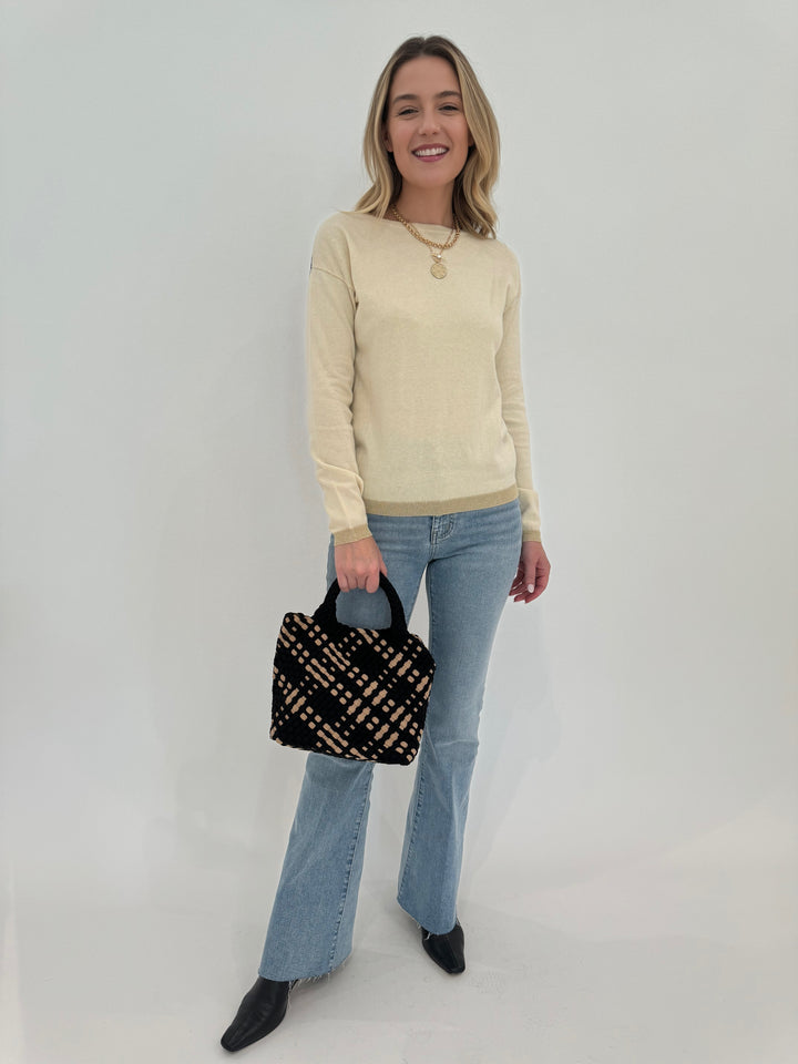 Elliott Lauren Tipping Point Cotton Cashmere Sweater in Starch, paired with Frame Le Easy Flare Raw Fray Jeans, and bag Sol and Selene Sky's The Limit Small Crossbody Bag in Black/Nude