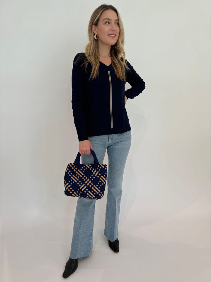 Peace of Cloth V-Neck Sweater With Ribbon Ruched Sleeve in Navy paired with Frame Le Easy Flare Raw Fray Jeans and Sol and Selene Sky's The Limit Small Tote Bag in Navy/Nude