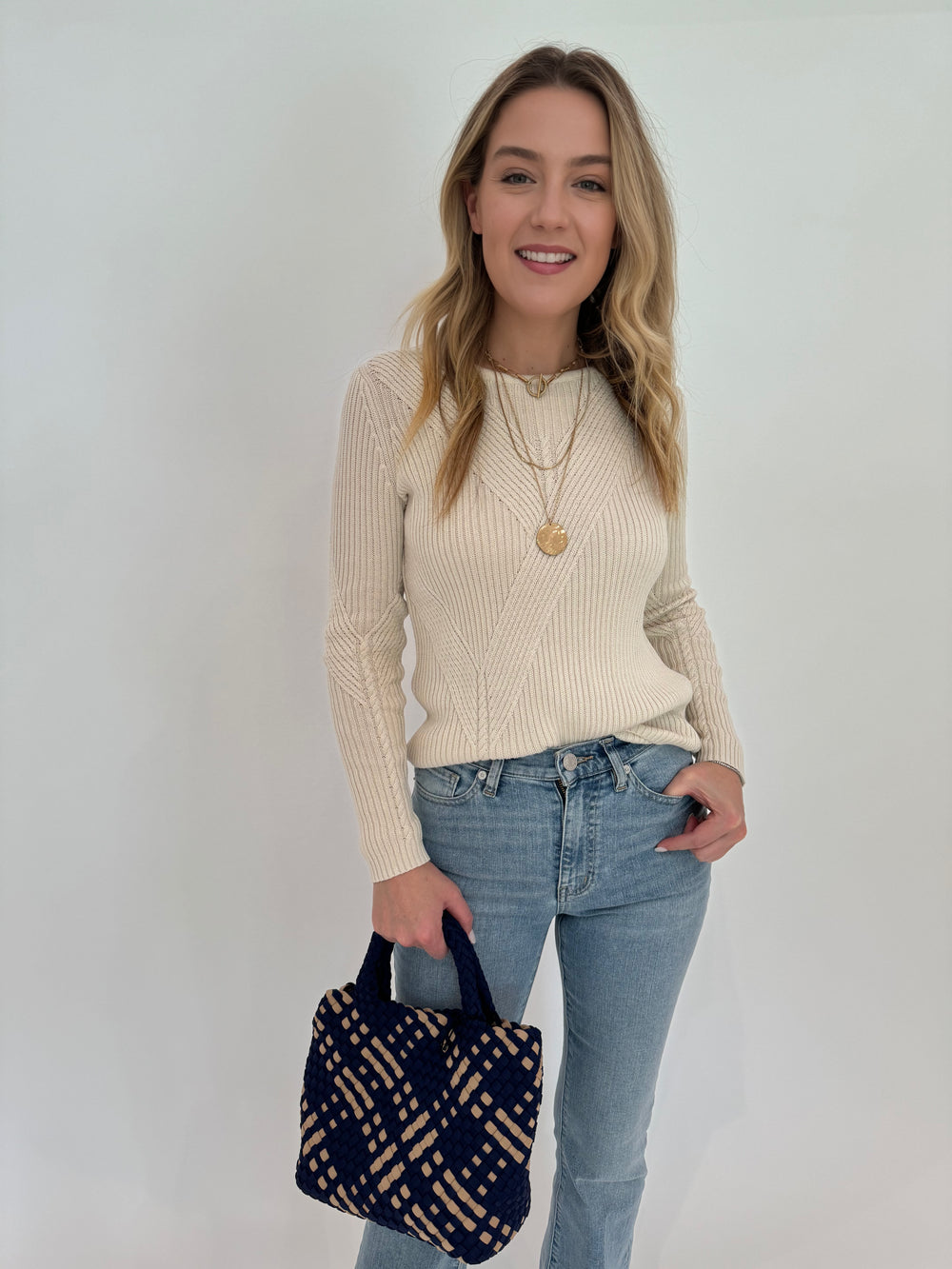 Peace of Cloth Cotton Crew Jacquard Sweater in Ecru paired with Frame Le Easy Flare Raw Fray Jeans and Sol and Selene Sky's Small Tote Bag in Navy/Nude