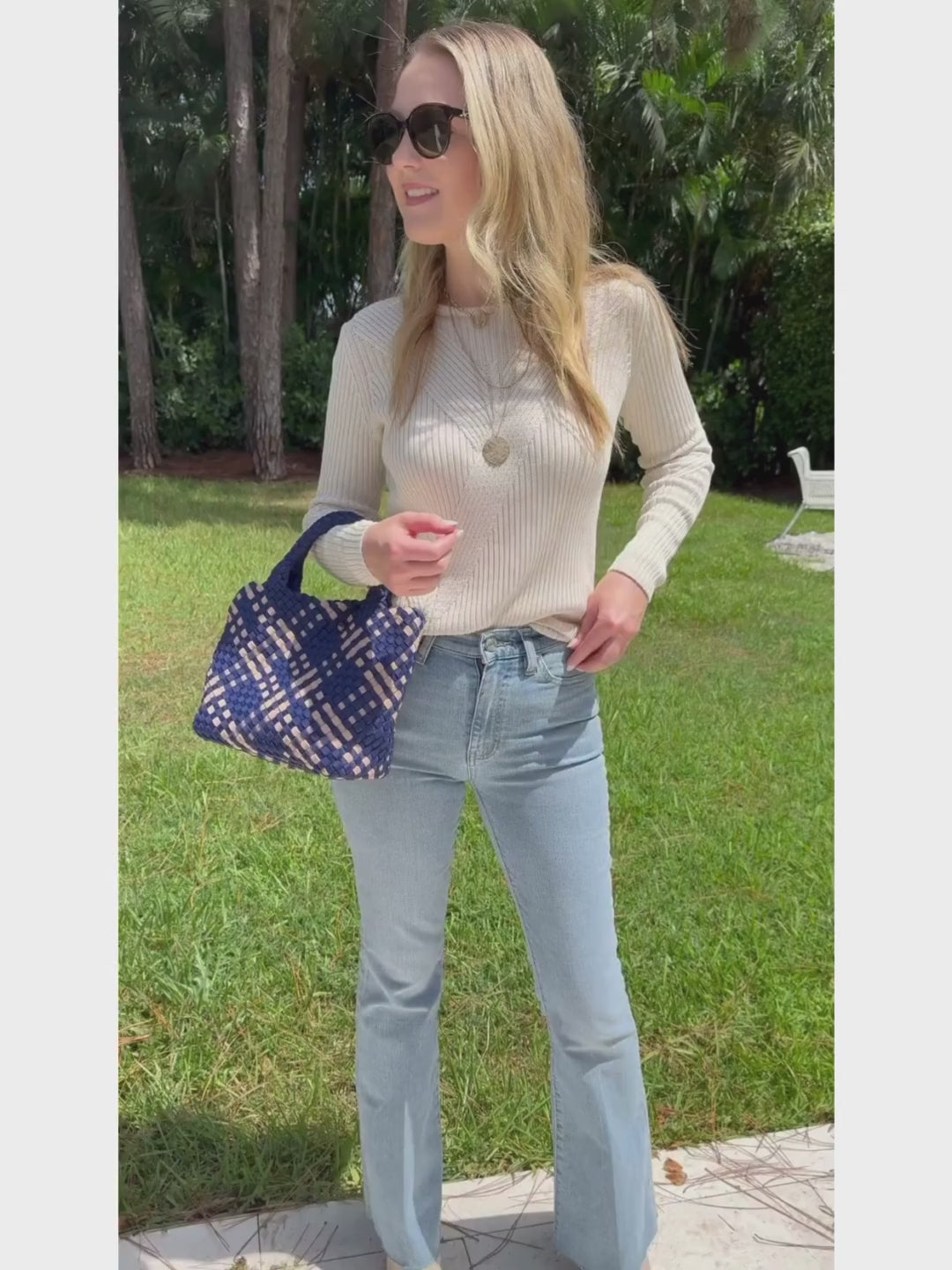 Peace of Cloth Cotton Crew Jacquard Sweater in Ecru paired with Frame Le Easy Flare Raw Fray Jeans and Sol and Selene Sky's Small Tote Bag in Navy/Nude