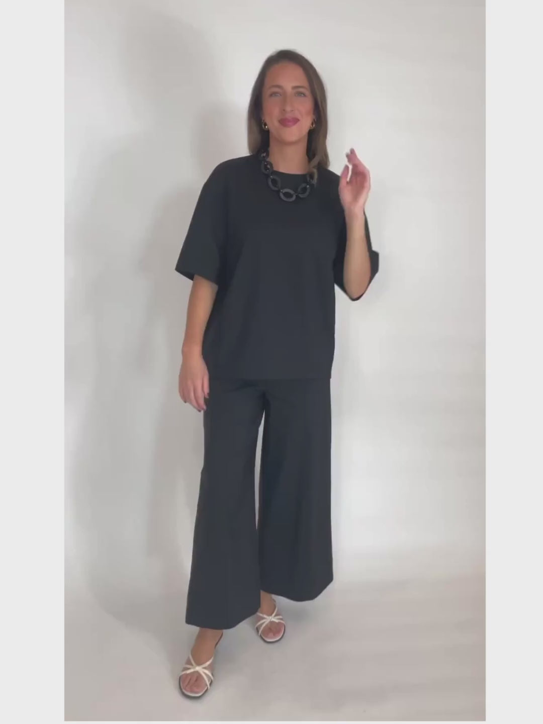 Simkhai Aude Cotton Short Sleeve Top in Black paired with matching Kallin Cropped Wide Leg Pants in Black  available at Barbara Katz